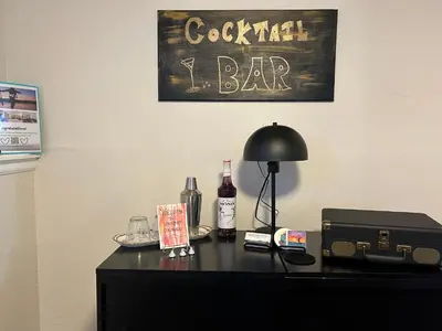a black desk with a black lamp and a bar sign at Longmont board games, beds, and boats - 2BR in Longmont
