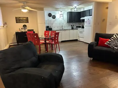 a living room with a couch and a table and chairs at Longmont board games, beds, and boats - 2BR in Longmont