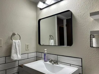 a bathroom with a sink and a large mirror at Longmont board games, beds, and boats - 2BR in Longmont