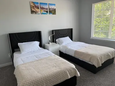 two beds sitting next to each other in a bedroom at CENTRAL DENVER FAMILY HOMe in Denver