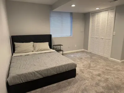 a bedroom with a large bed and a window at CENTRAL DENVER FAMILY HOMe in Denver