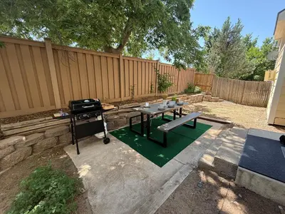 a picnic table in a backyard with a fence at CENTRAL DENVER FAMILY HOMe in Denver