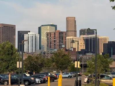 a parking lot with cars parked in front of a city at CENTRAL DENVER FAMILY HOMe in Denver