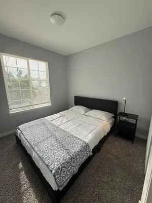 a bedroom with a bed and a window at CENTRAL DENVER FAMILY HOMe in Denver