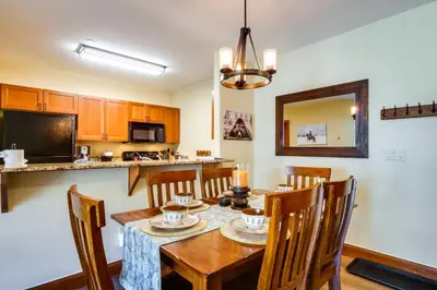 a kitchen and dining room with a table and chairs at Family Ski Trip! Upscale Keystone Condo Near Lift in Dillon