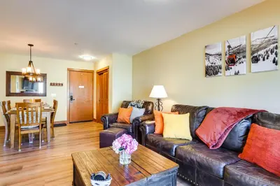 a living room with a leather couch and a table at Family Ski Trip! Upscale Keystone Condo Near Lift in Dillon
