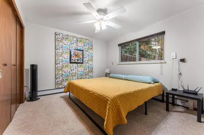 a bedroom with a bed and a ceiling fan at Steps to Lake Mcintosh, Basement 1BR in Longmont
