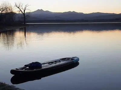 a boat sitting in the middle of a lake at Steps to Lake Mcintosh, Basement 1BR in Longmont