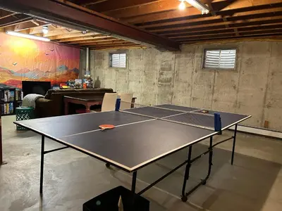 a ping pong table in a room with a ping pong ball at Steps to Lake Mcintosh, Basement 1BR in Longmont
