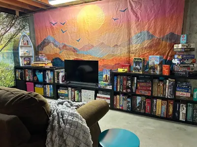 a living room with a book shelf filled with books at Steps to Lake Mcintosh, Basement 1BR in Longmont