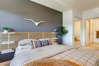 a bedroom with a large bed with a wooden headboard at Walkable Condo 5 Mi to Winter Park Resort! in Fraser