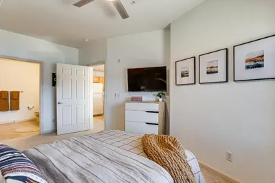 a bedroom with a bed and a tv on a wall at Walkable Condo 5 Mi to Winter Park Resort! in Fraser