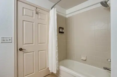 a bathroom with a tub and a shower curtain at Walkable Condo 5 Mi to Winter Park Resort! in Fraser