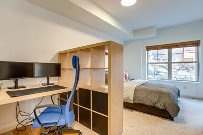 a bedroom with a desk and a bed and a computer at Walkable Condo 5 Mi to Winter Park Resort! in Fraser