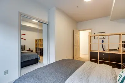 a bedroom with a bed and a glass wall at Walkable Condo 5 Mi to Winter Park Resort! in Fraser