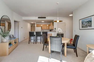 a dining room and kitchen with a table and chairs at Walkable Condo 5 Mi to Winter Park Resort! in Fraser