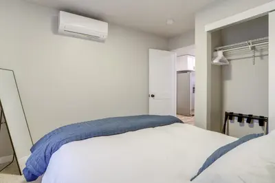 a bedroom with a white bed with a blue blanket at Modern and Pet-Friendly! Northern Colorado Retreat