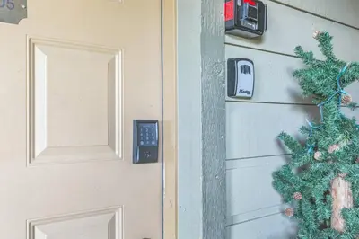 a door with a phone on it next to a christmasreath at Ski & Golf by Sweetheart Stays in Granby