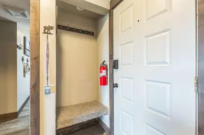 a room with a white door and a fire hydrant at Ski & Golf by Sweetheart Stays in Granby
