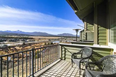 a balcony with two chairs and a view of the mountains at Private Sauna! Spacious Ski Condo Near Winter Park in Fraser