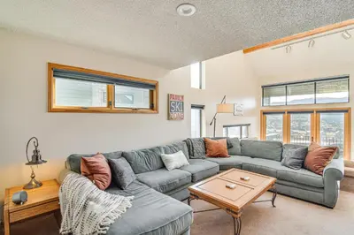 a living room with a couch and a table at Private Sauna! Spacious Ski Condo Near Winter Park in Fraser