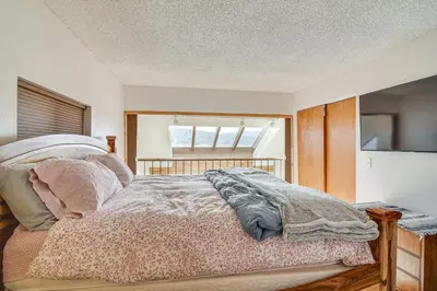 a bedroom with a bed and a window at Private Sauna! Spacious Ski Condo Near Winter Park in Fraser