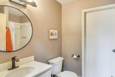 a bathroom with a toilet and a sink and a mirror at Private Sauna! Spacious Ski Condo Near Winter Park in Fraser