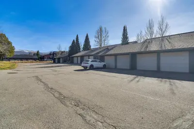 a white car parked in front of a building at Private Sauna! Spacious Ski Condo Near Winter Park in Fraser