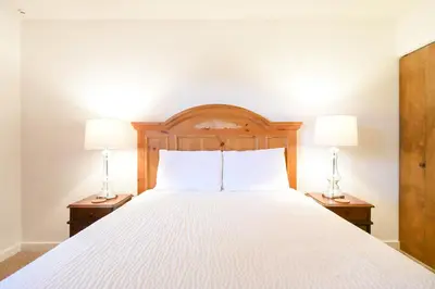 a bedroom with a bed with two lamps on tables at Mountainside Aspenview Condo - Great Year-Round Location in Frisco