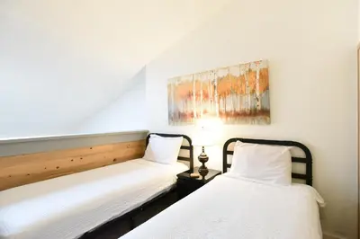 two beds in a room with a painting on the wall at Mountainside Aspenview Condo - Great Year-Round Location in Frisco