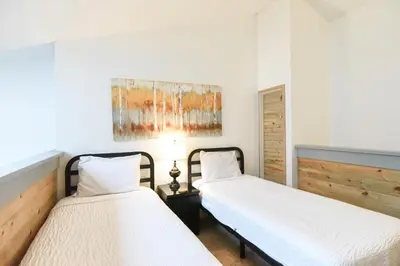 a bedroom with two beds and a painting on the wall at Mountainside Aspenview Condo - Great Year-Round Location in Frisco