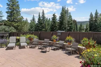 a patio with chairs and a table and a fence at Mountainside Aspenview Condo - Great Year-Round Location in Frisco