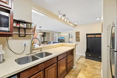 a kitchen with a sink and a refrigerator at Key Condo Slopeside - Walk to Lifts, Pool/Hot Tub, Fantastic Views in Keystone