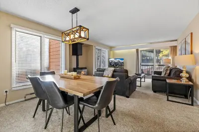 a living room with a wooden table and chairs at Key Condo Slopeside - Walk to Lifts, Pool/Hot Tub, Fantastic Views in Keystone