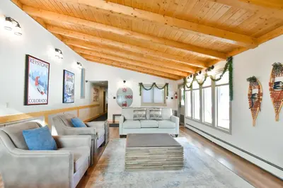 a living room with a wooden ceiling at Key Condo Slopeside - Walk to Lifts, Pool/Hot Tub, Fantastic Views in Keystone