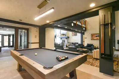 a pool table in the middle of a living room at The Springs at River Run - Walk to Lifts, Pool Hot Tubs in Keystone