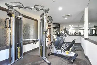a gym with a treadmill and a bike in a room at The Springs at River Run - Walk to Lifts, Pool Hot Tubs in Keystone