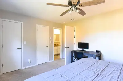 a bedroom with a bed and a ceiling fan at Windwood Bluebird Townhome - Walk to Town, Close to Everything in Frisco