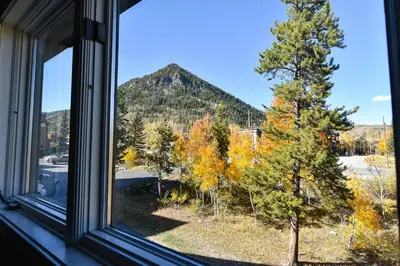 a window with a view of a mountain at Windwood Bluebird Townhome - Walk to Town, Close to Everything in Frisco