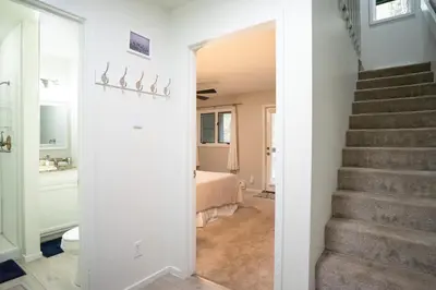 a hallway with a stairway leading to a bedroom at Windwood Bluebird Townhome - Walk to Town, Close to Everything in Frisco