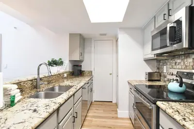 a kitchen with marble counter tops and a sink at Lake Forest Alpine View: Lake Mountain Views in Frisco