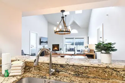 a kitchen with a sink and a living room at Lake Forest Alpine View: Lake Mountain Views in Frisco