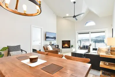 a living room with a dining room table and a fireplace at Lake Forest Alpine View: Lake Mountain Views in Frisco