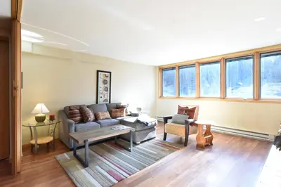 a living room with a couch and a table at Liftside Condo - Walk to Lifts, Pool Hot Tub in Keystone