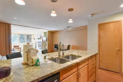 a kitchen with a sink and a counter top at Liftside Condo - Walk to Lifts, Pool Hot Tub in Keystone