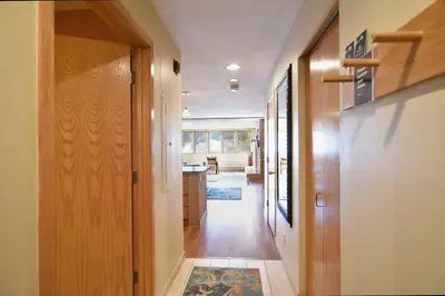 a hallway of a home with a kitchen and a living room at Liftside Condo - Walk to Lifts, Pool Hot Tub in Keystone