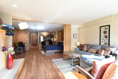 a living room with a couch and a table at Liftside Condo - Walk to Lifts, Pool Hot Tub in Keystone