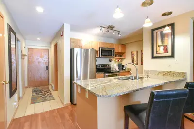 a kitchen with a sink and a refrigerator at Liftside Condo - Walk to Lifts, Pool Hot Tub in Keystone