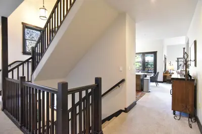 a staircase in a living room with a stair railing at Red Hawk Townhome - Walk to Lifts, Pool/Hot Tub Access in Keystone