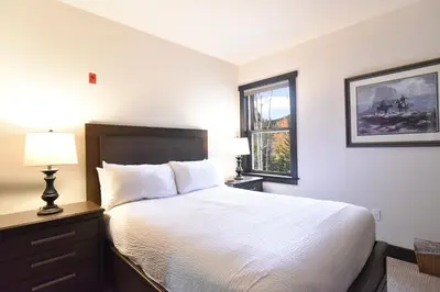 a hotel room with a bed and a window at Red Hawk Townhome - Walk to Lifts, Pool/Hot Tub Access in Keystone
